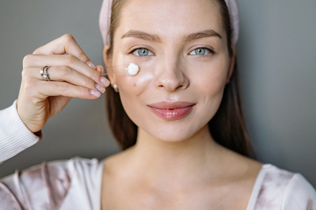 A woman applying face cream