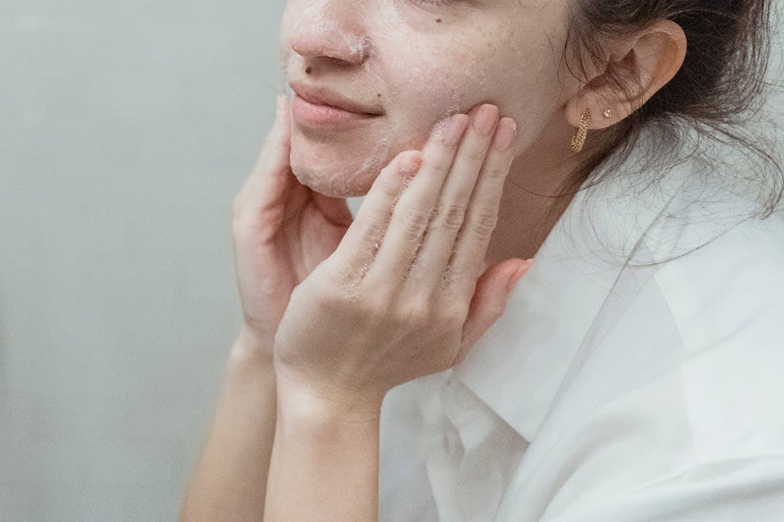 A woman double cleansing her face
