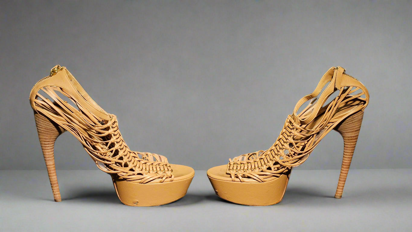 Tan high-heeled shoes with woven design on a gray background