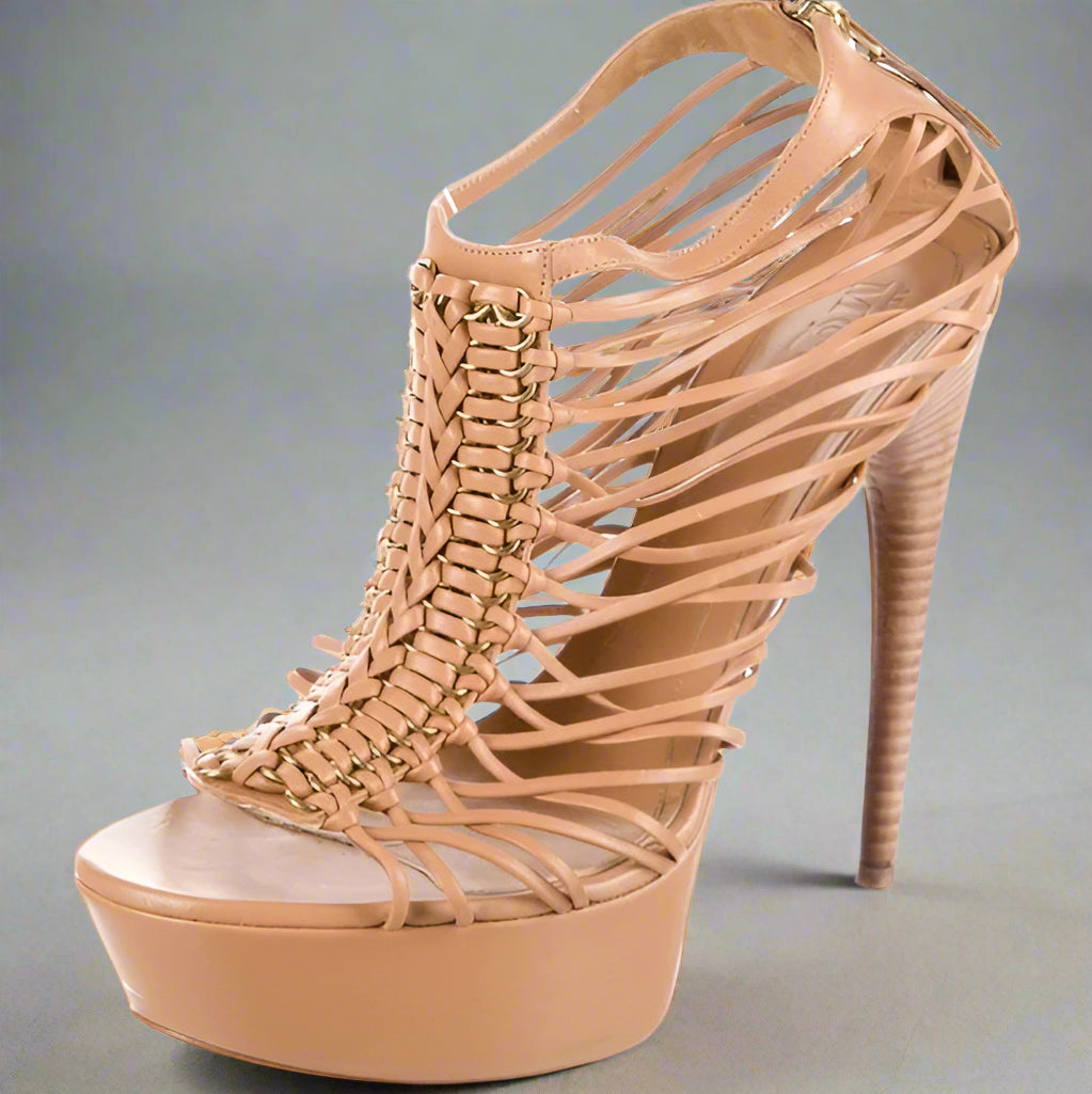 Beige high-heeled sandal with woven design on a white background