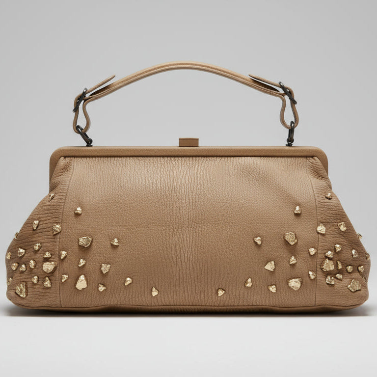 Beige handbag with decorative studs on a white background