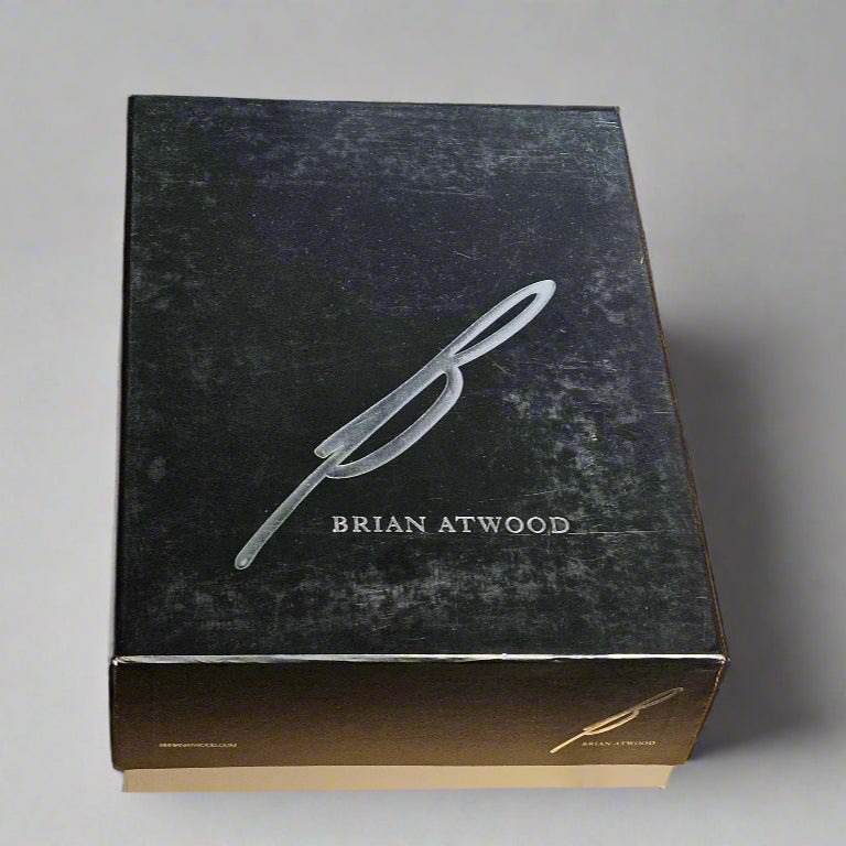 Black box with 'Brian Atwood' branding on a cardboard surface