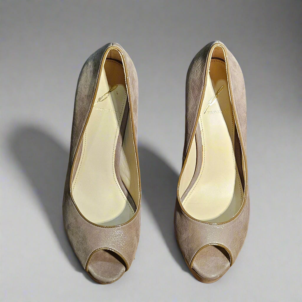 Pair of beige open-toe high-heeled shoes on a gray background