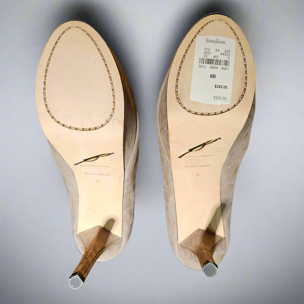 Shoe soles with brand label on a cardboard surface against a blue fabric background