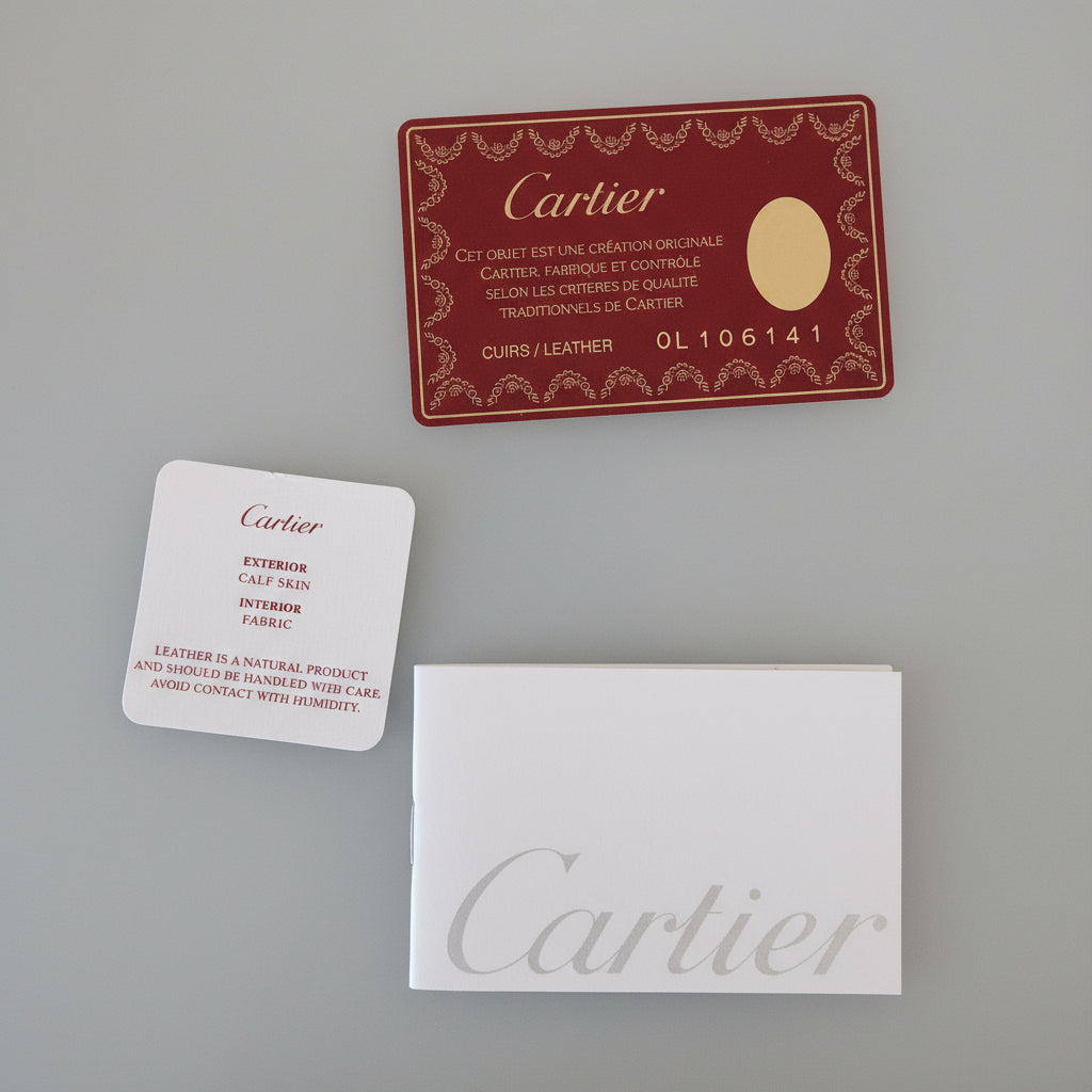 Cartier business cards on a reflective surface