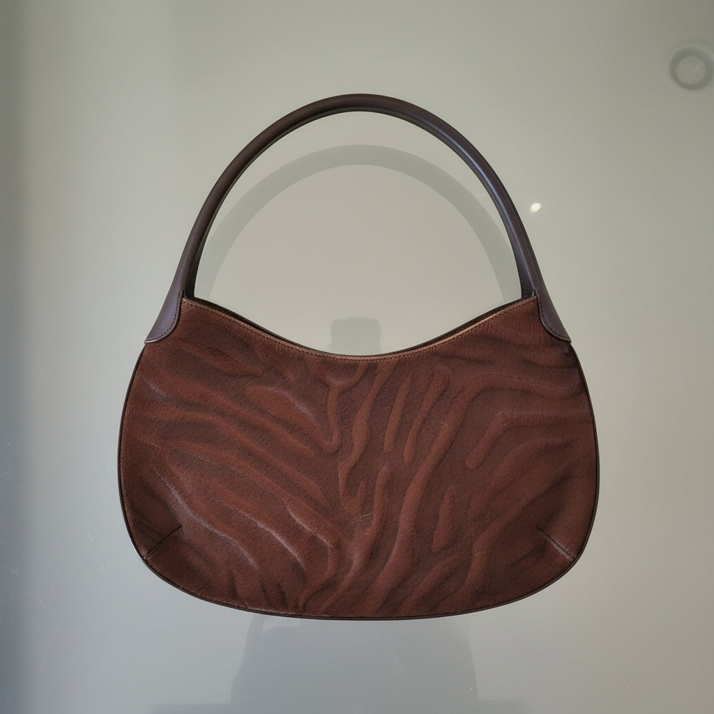 Brown textured bag on a light gray surface