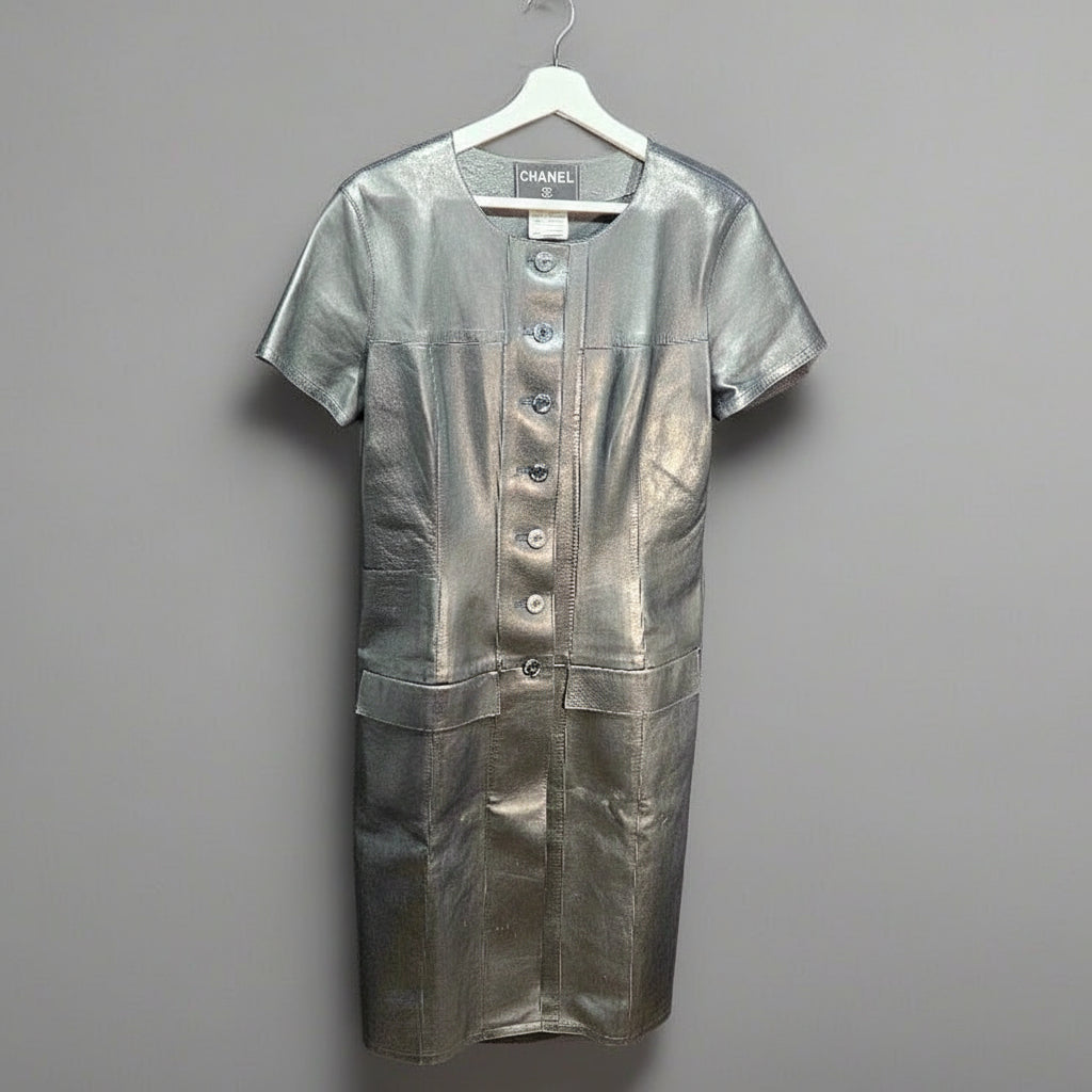 Black leather dress on a hanger against a gray background