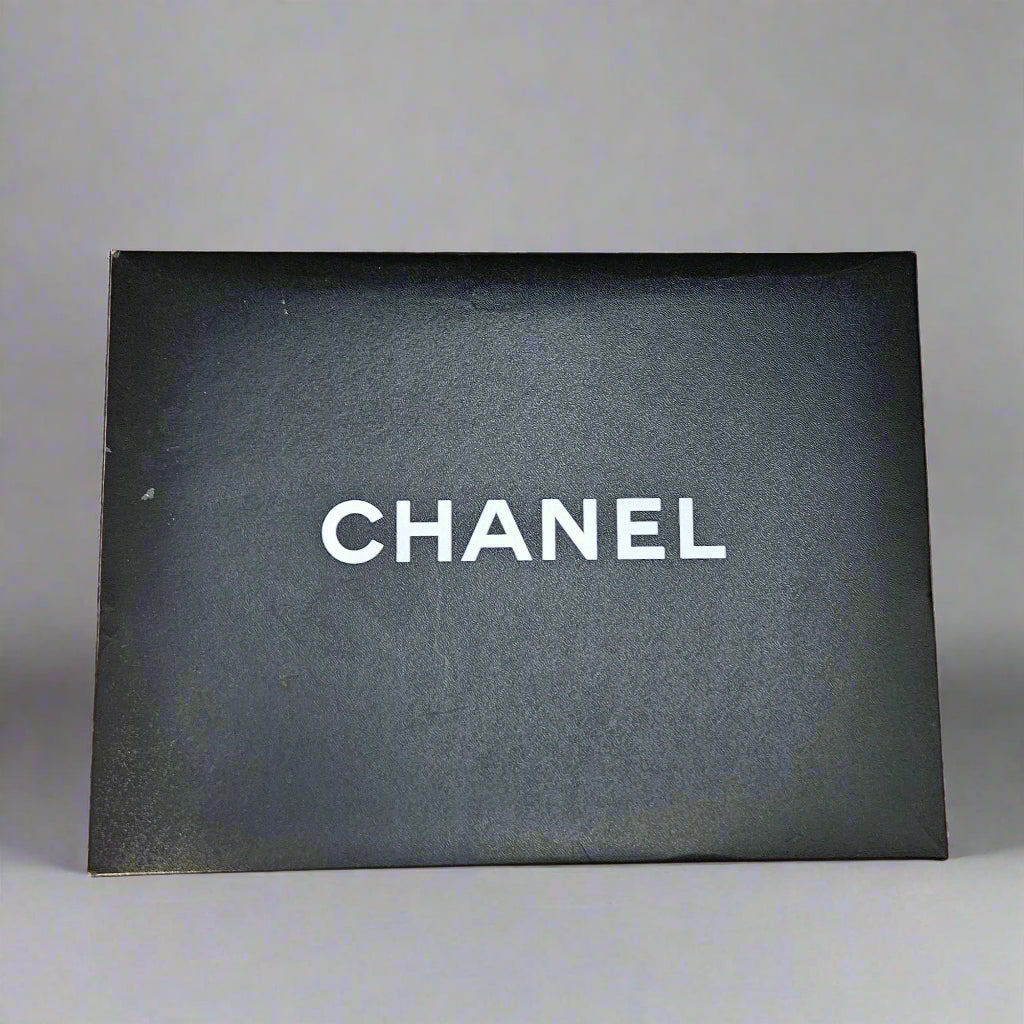 Chanel box with a black interior on a cardboard base