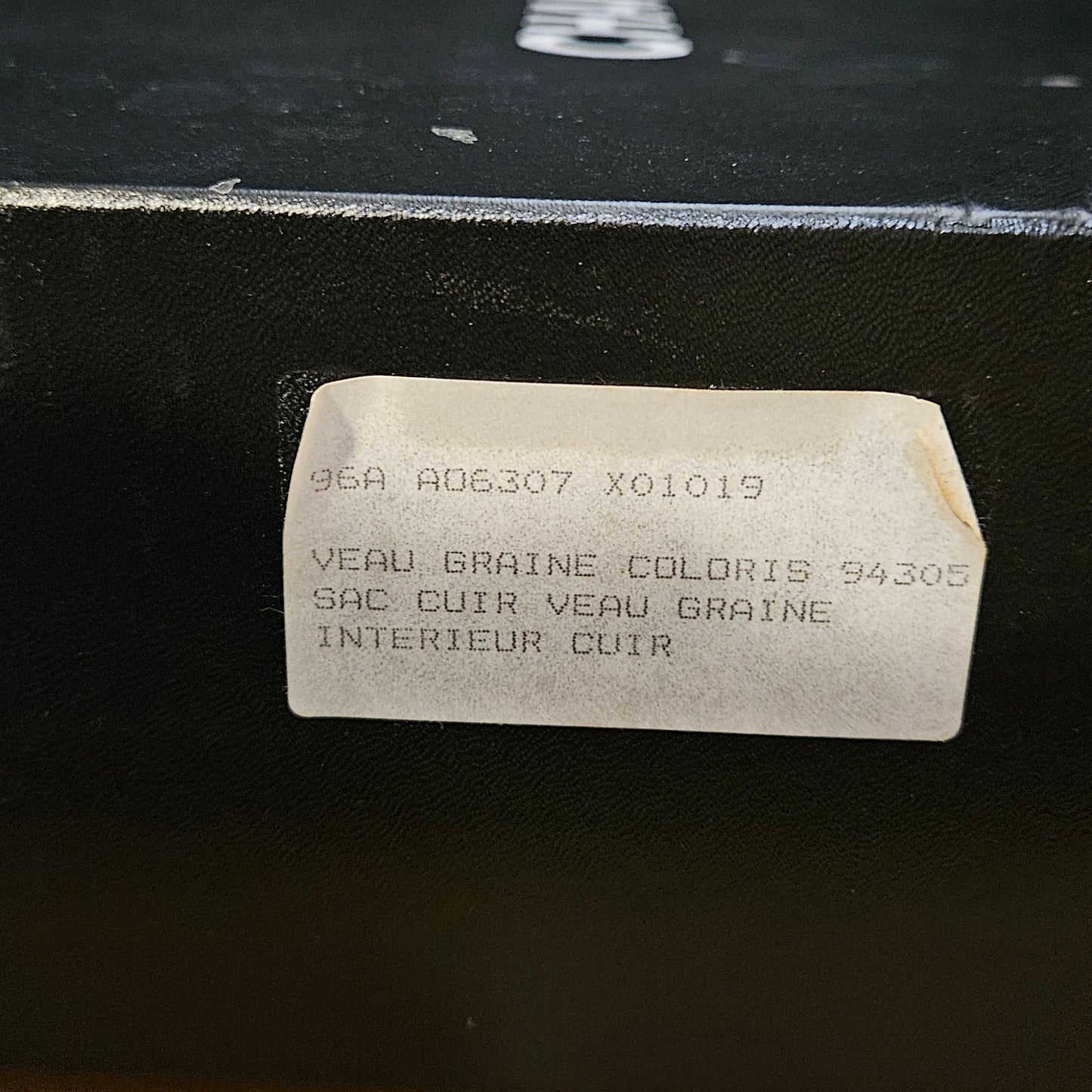 White rectangular label with text on a black surface