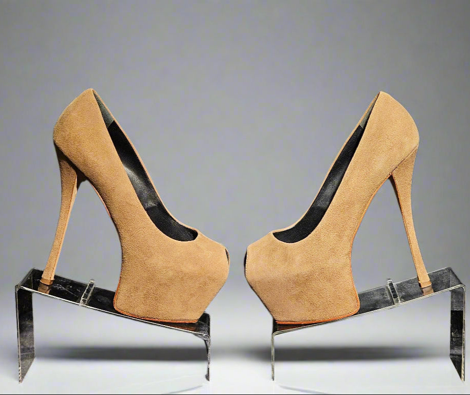 Pair of tan high-heeled shoes on a clear stand against a gray background