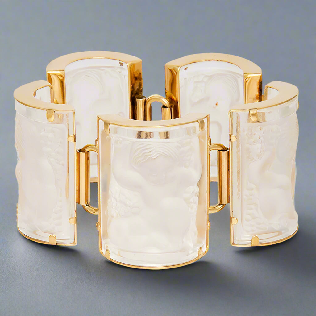 Gold and white cuff bracelet on a gray background