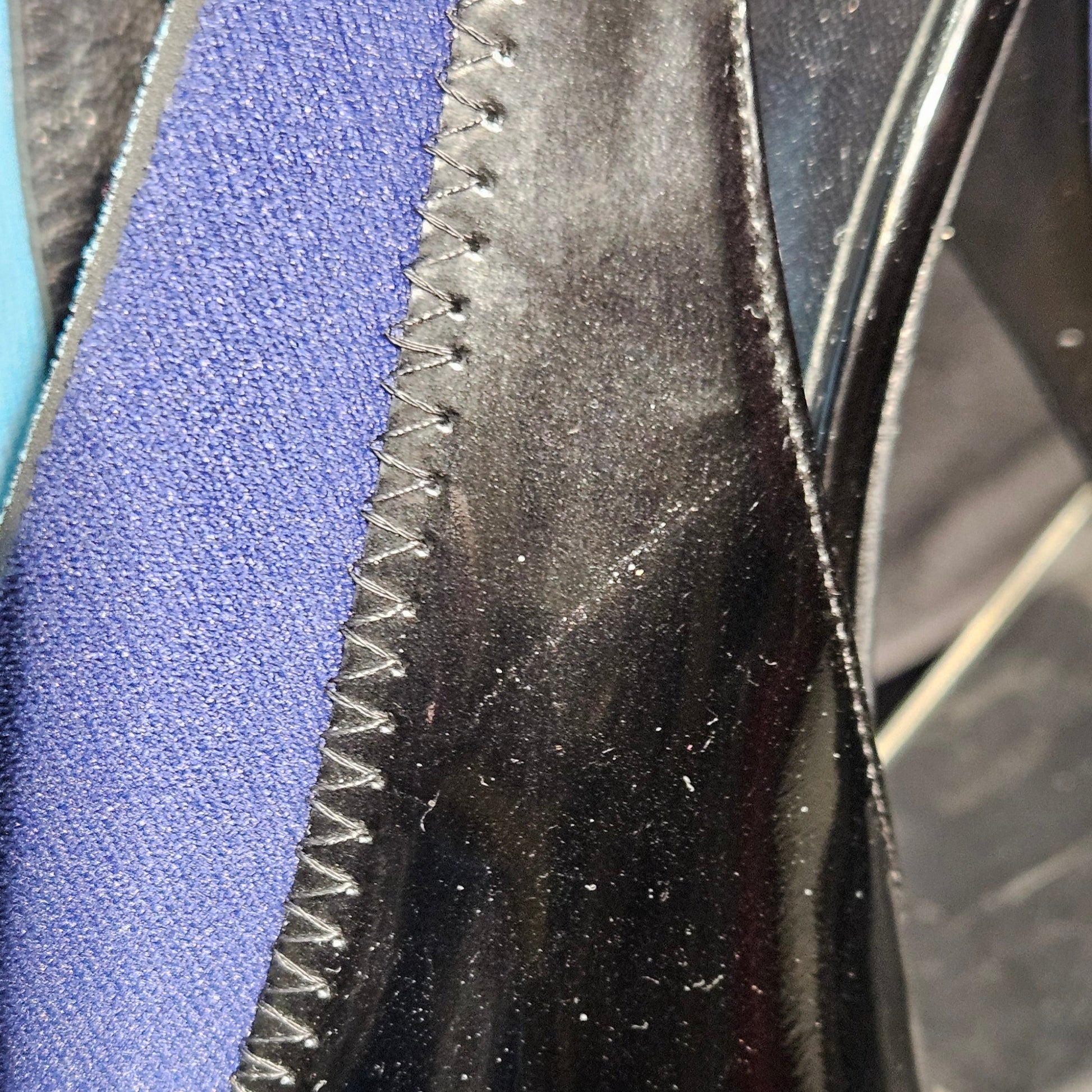 Close-up of a black rubber gasket with a textured edge on a metallic surface.