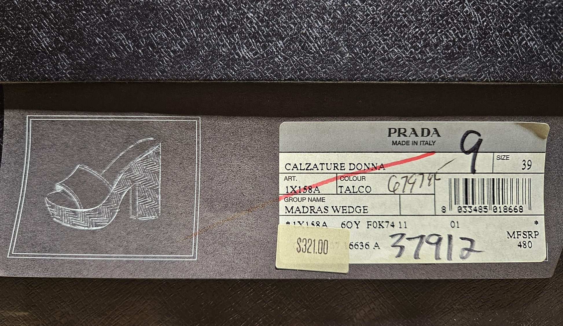 Prada shoe tag with product details on a dark background