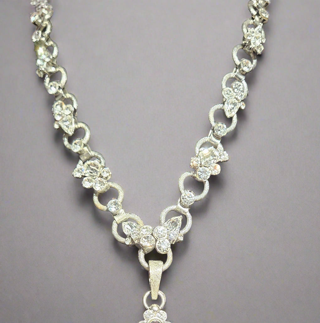 Silver necklace with butterfly pendant on a black background