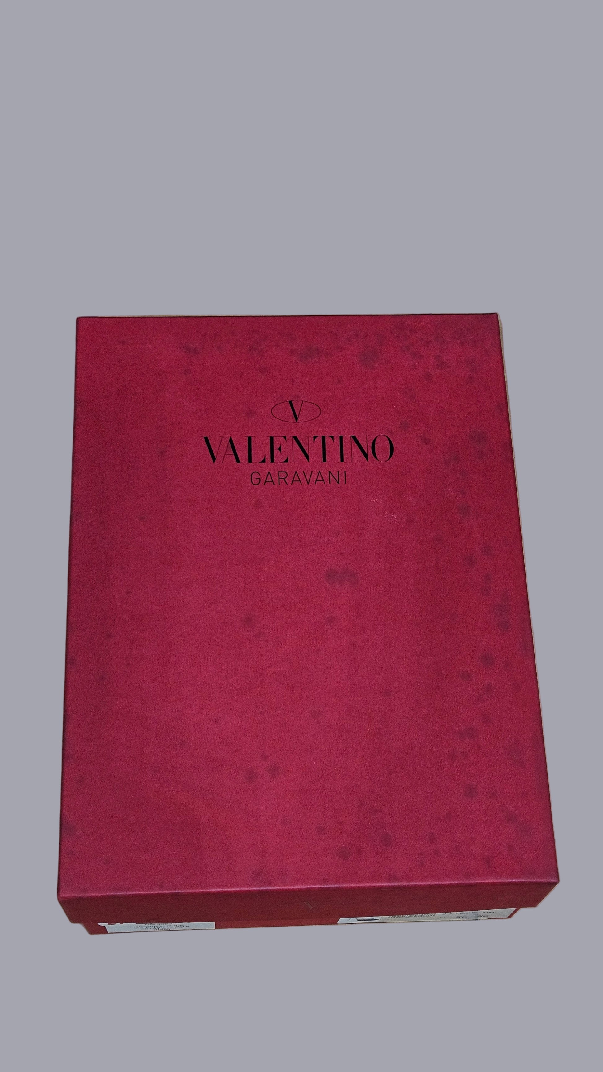 Red Valentino box on a stone surface