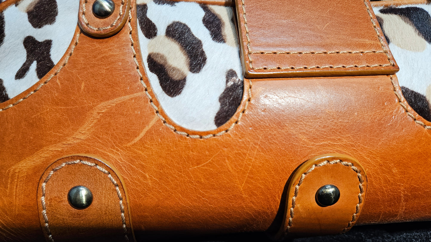 Close-up of a brown leather with leopard print accents
