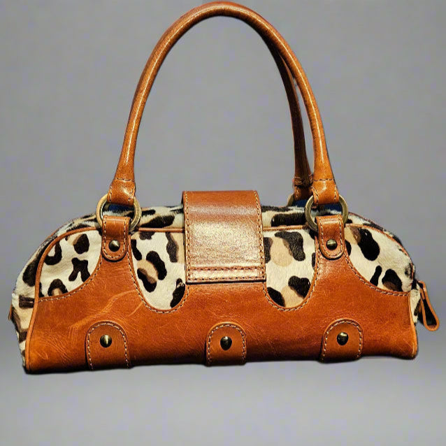 Brown handbag with leopard print accents on a gray background