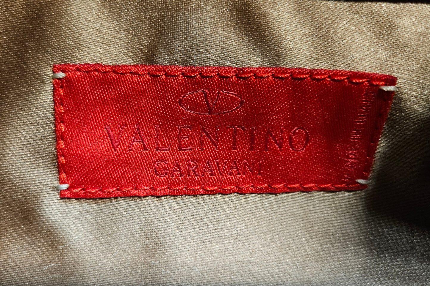 Red Valentino label on a beige fabric background