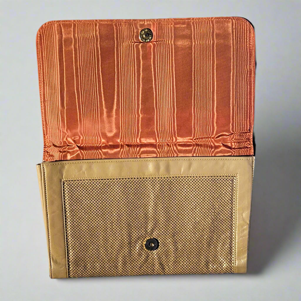 Handbag open to see lining on a gray background