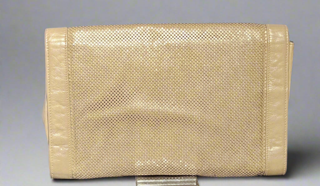 Beige textured clutch bag on a gray background