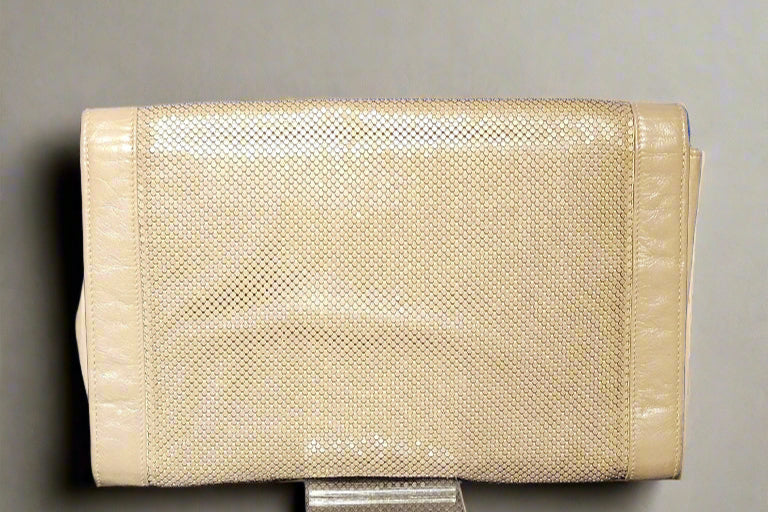 Beige textured clutch bag on a gray background