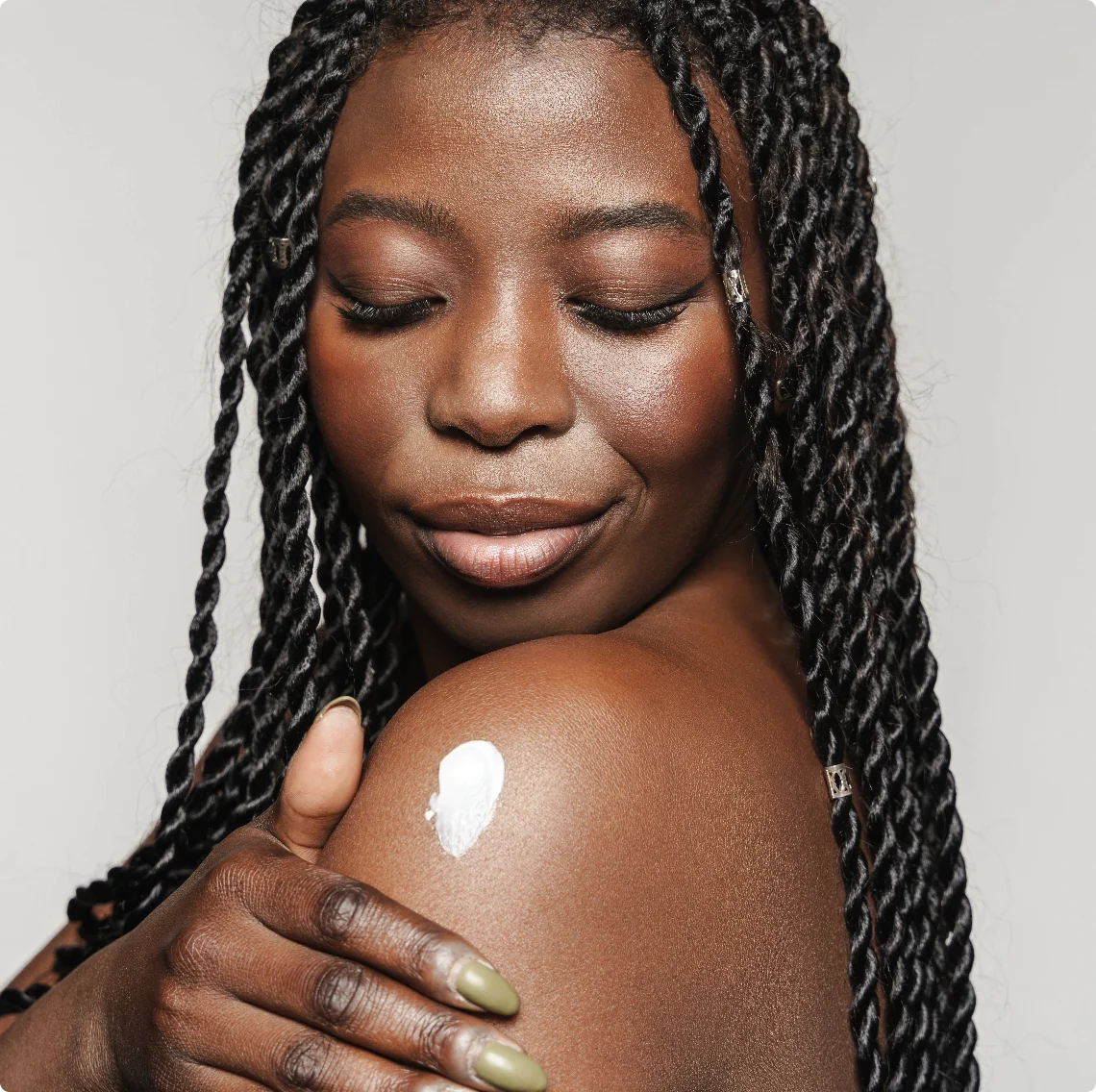 woman rubbing in cbd cream on her arm