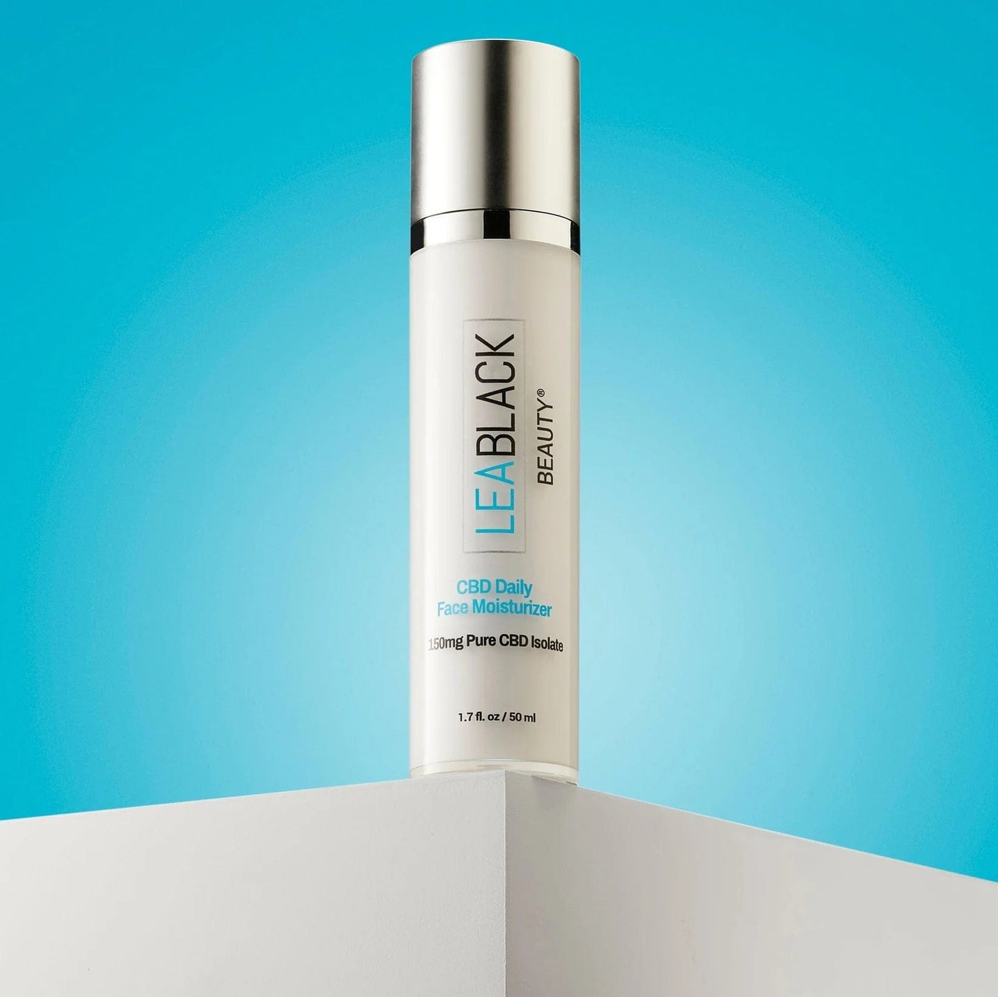 A bottle of Lea Black Beauty® CBD Daily Face Moisturizer on a countertop with a blue background