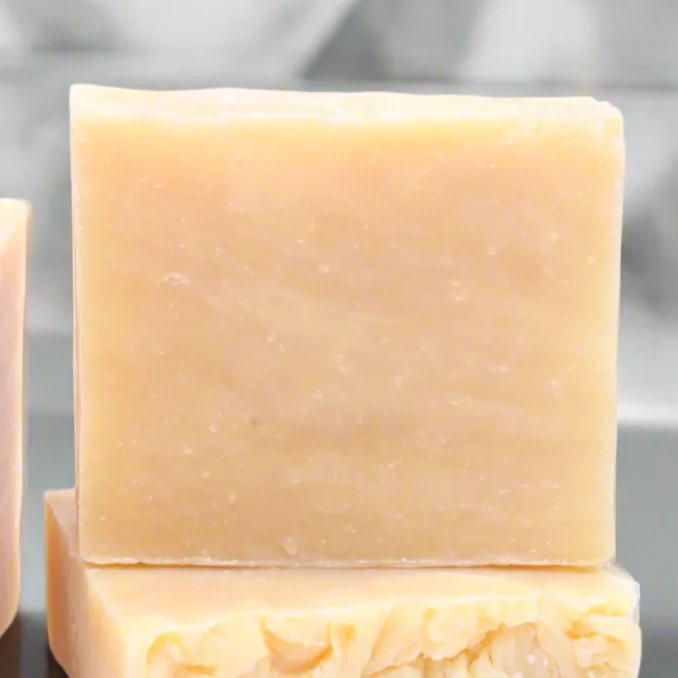 Two stacked goat milk soap bars
