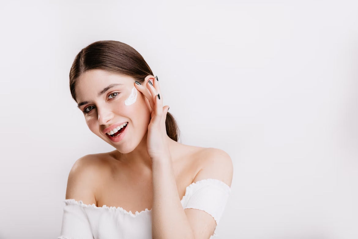 A woman applying cream to reverse signs of aging on her face
