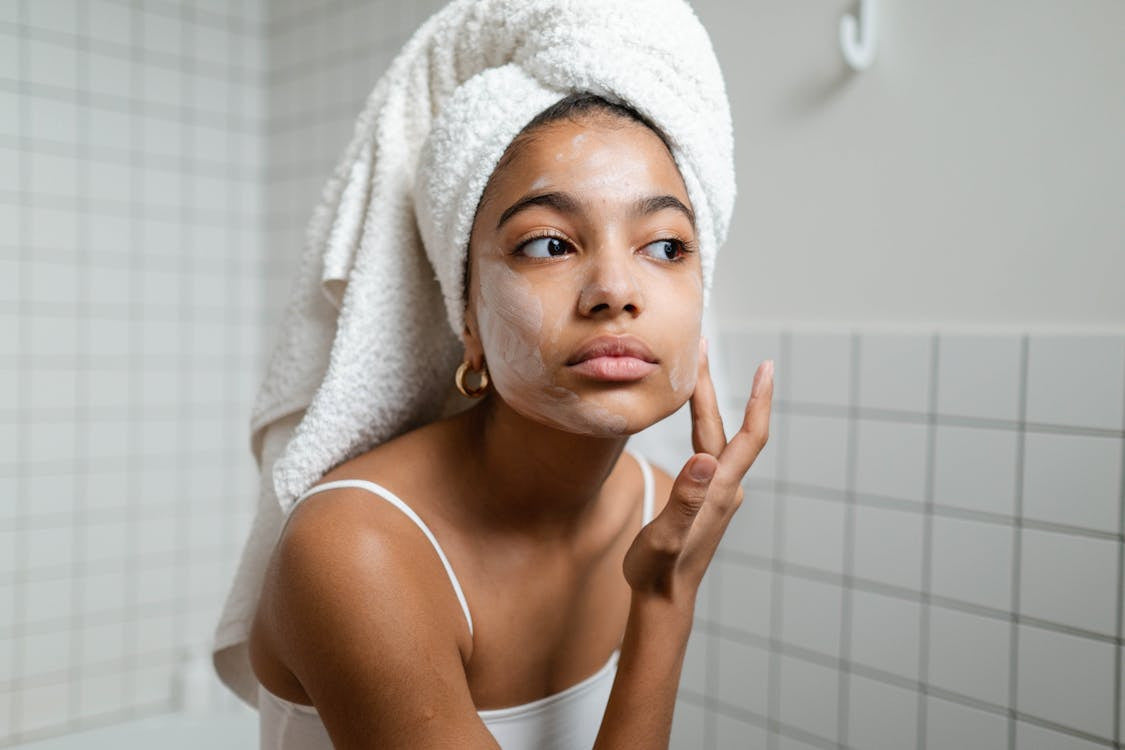 Woman exfoliating her face