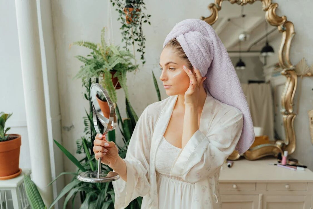 A mom in a bathrobe doing skincare