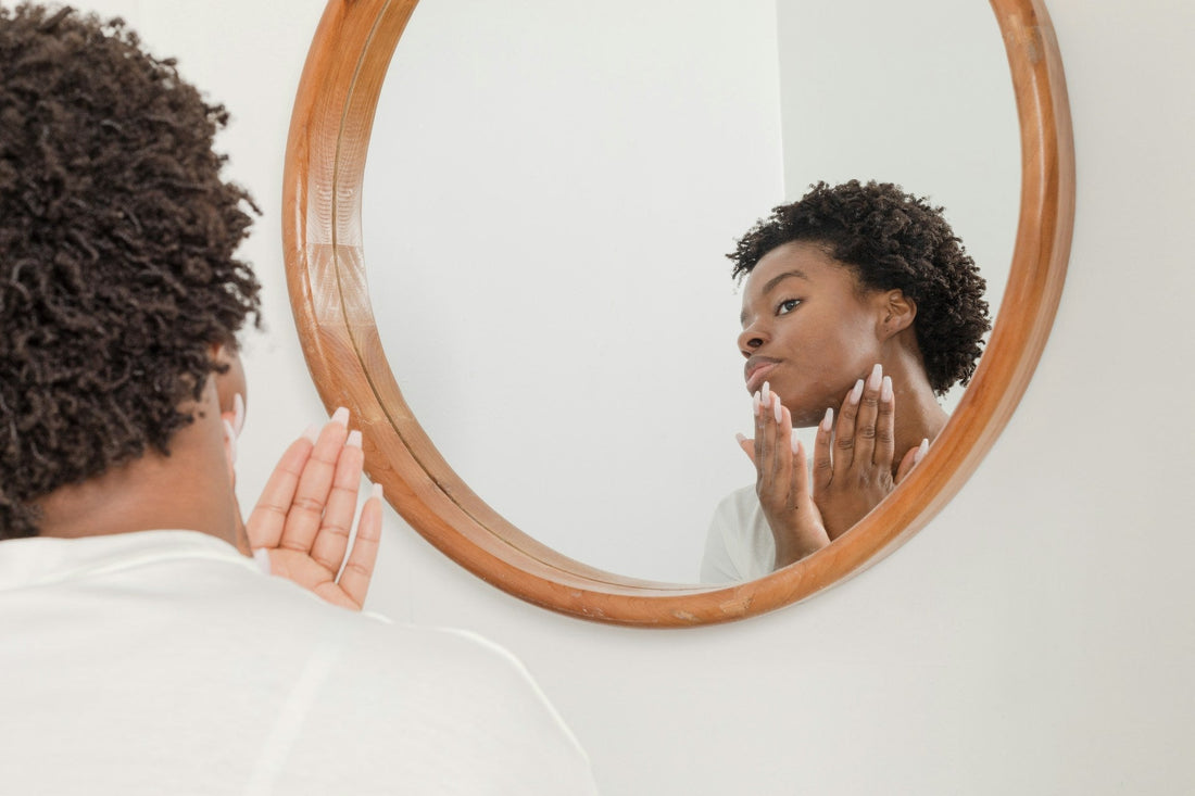 person looking in mirror at face