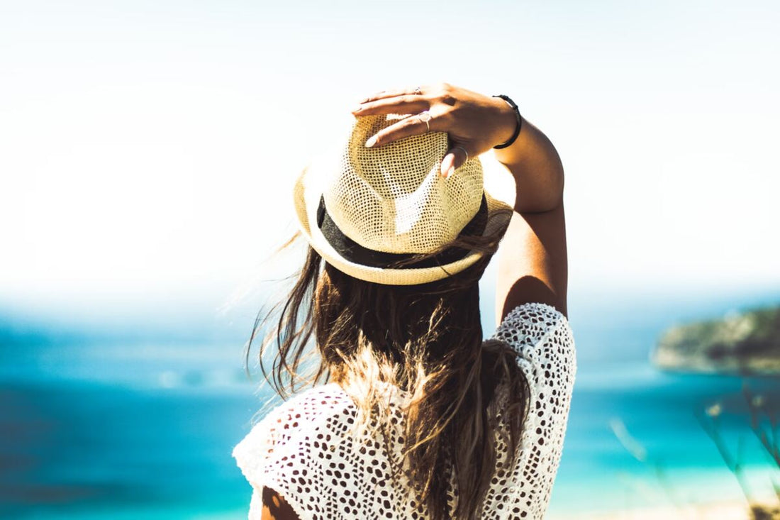 A woman looking at the ocean on a sunny summer day