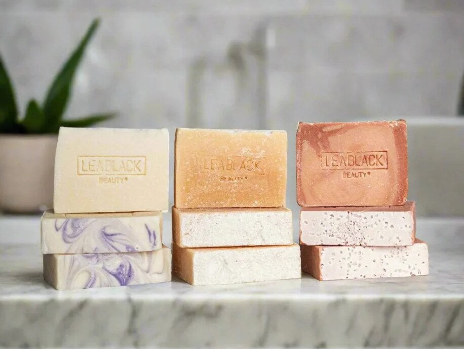 Three Beauty Bars on a marble countertop