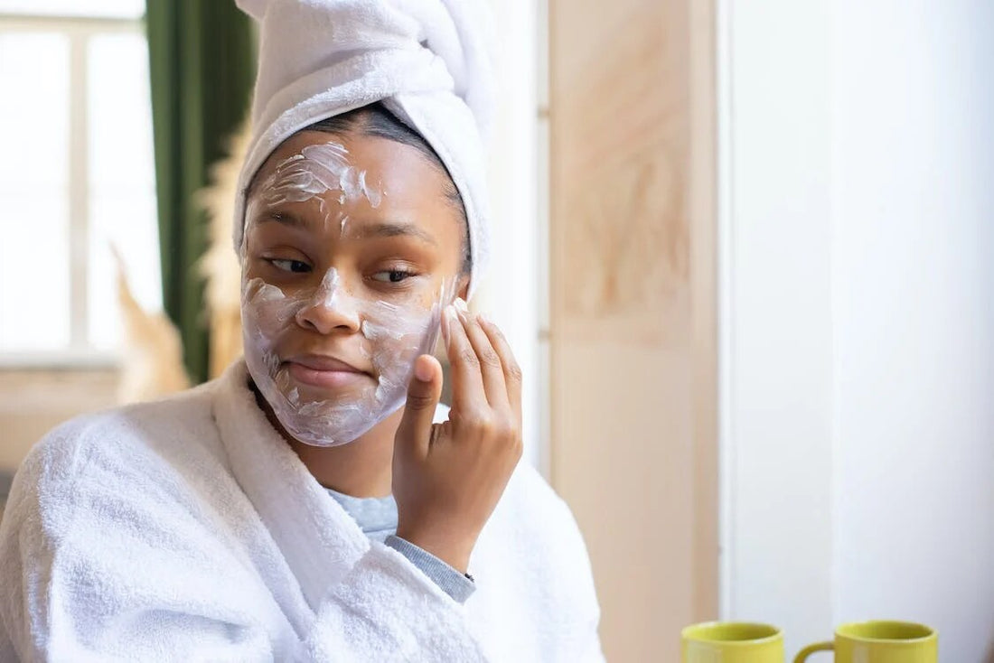 A woman applying face cream