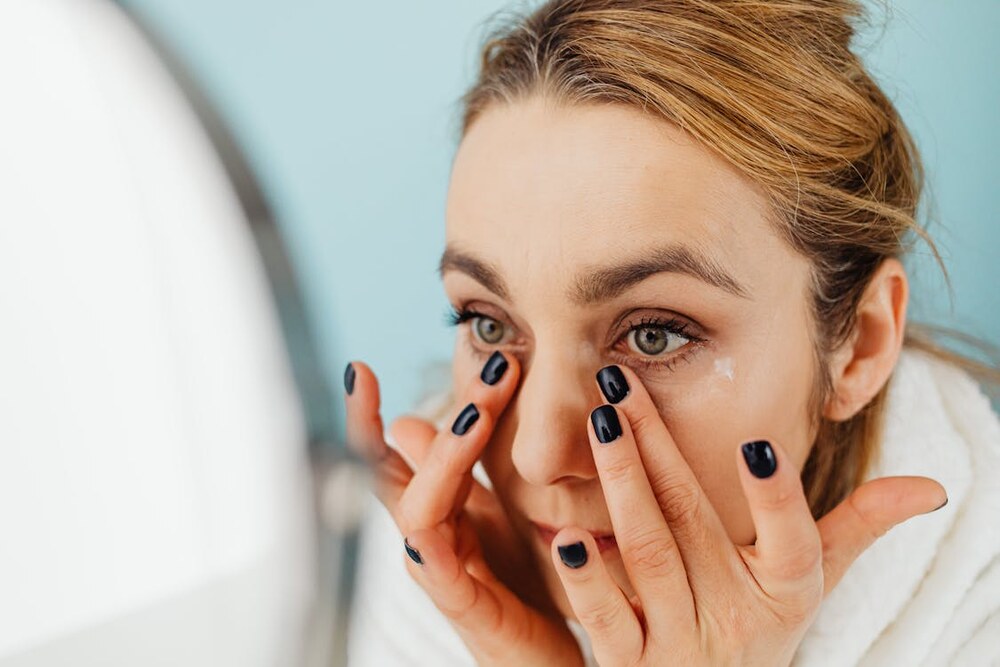 Woman applying eye cream