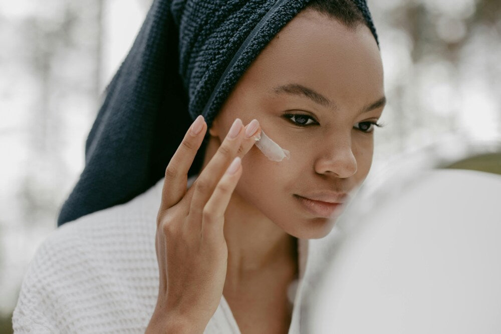 A woman with facial exfoliant cream on her cheek, enjoying the benefits of salicylic