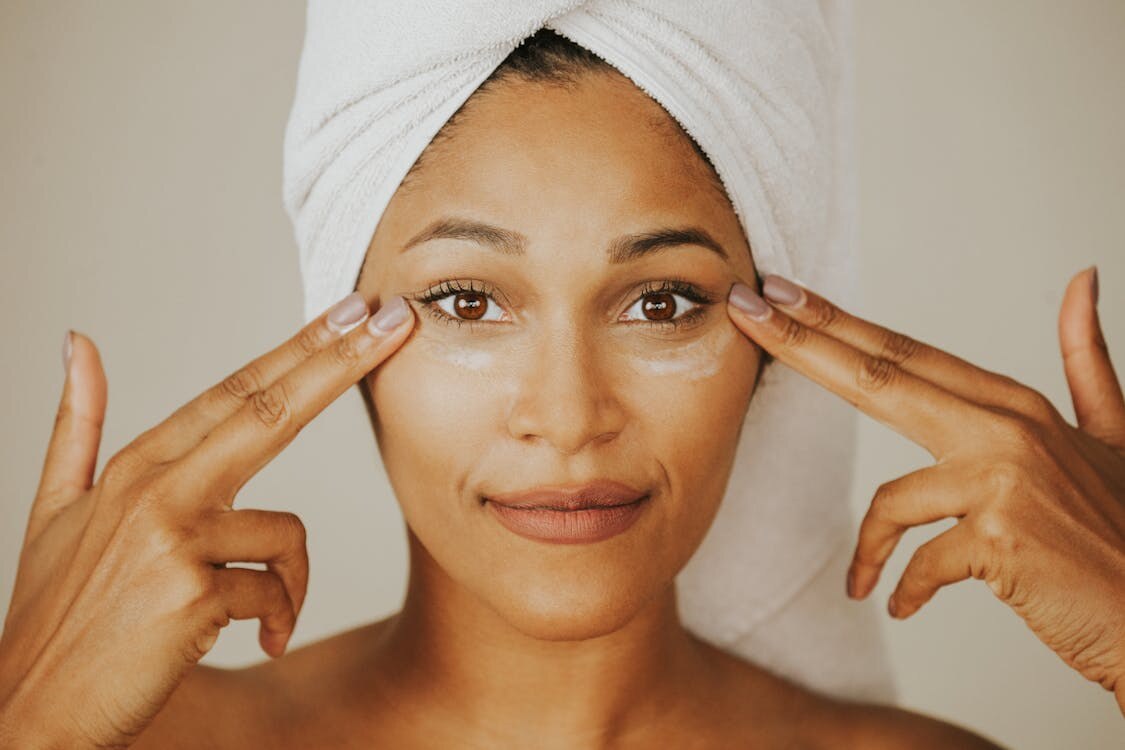 A woman applying under-eye cream