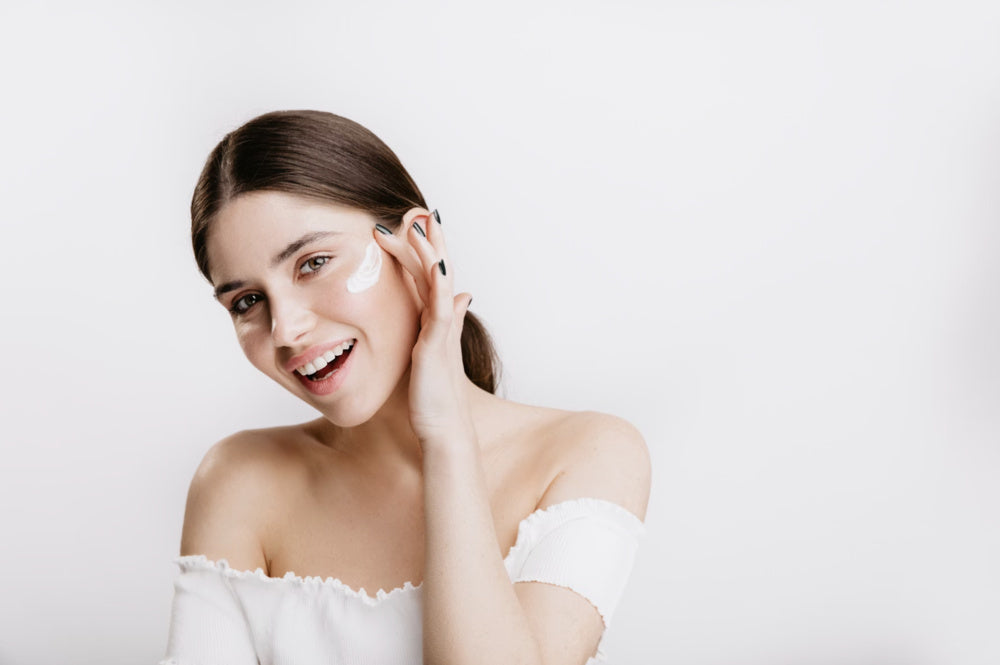 woman applying moisturizer on her face