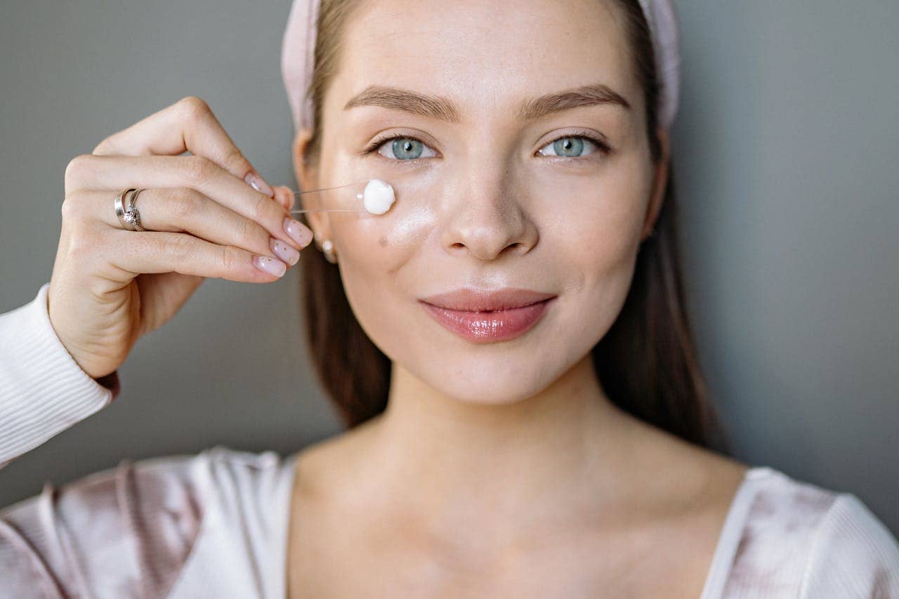 Woman doing a minimalist natural skincare routine with face cream