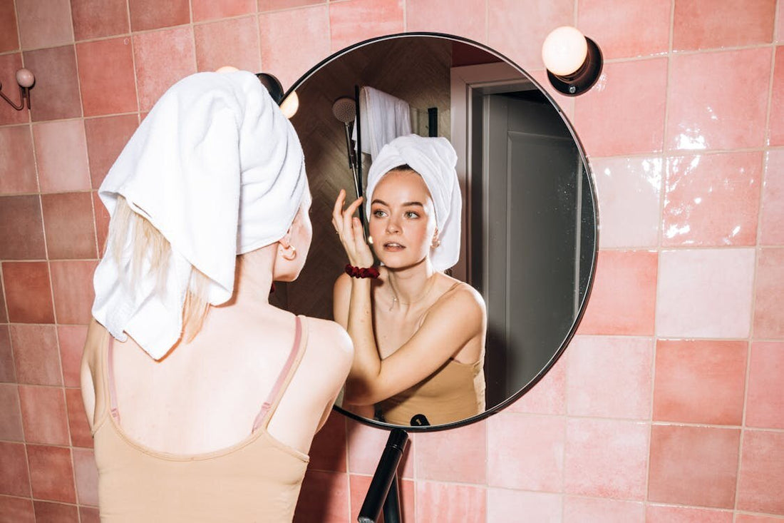 Woman doing a simple skincare routine in front of a mirror