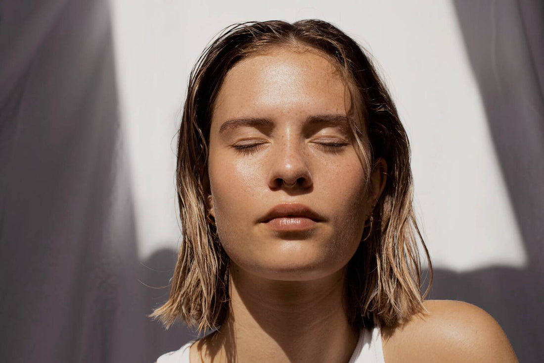 woman in the sunshine with eyes closed