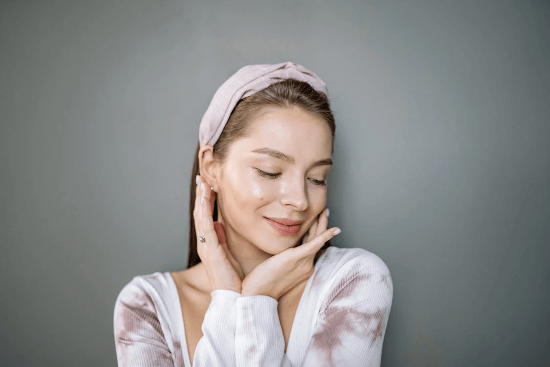 A woman with both her hands on her cheeks