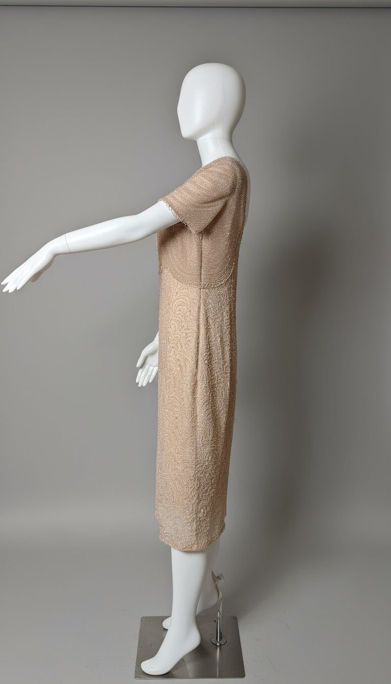 Mannequin wearing a beige dress against a gray background