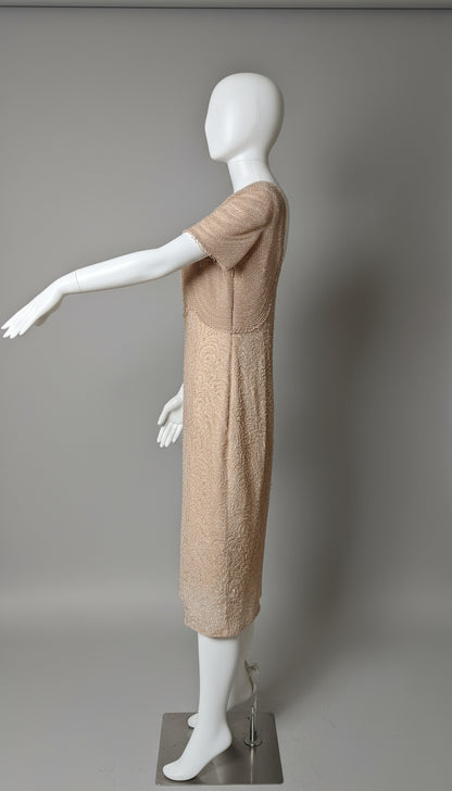 Mannequin wearing a beige dress against a gray background