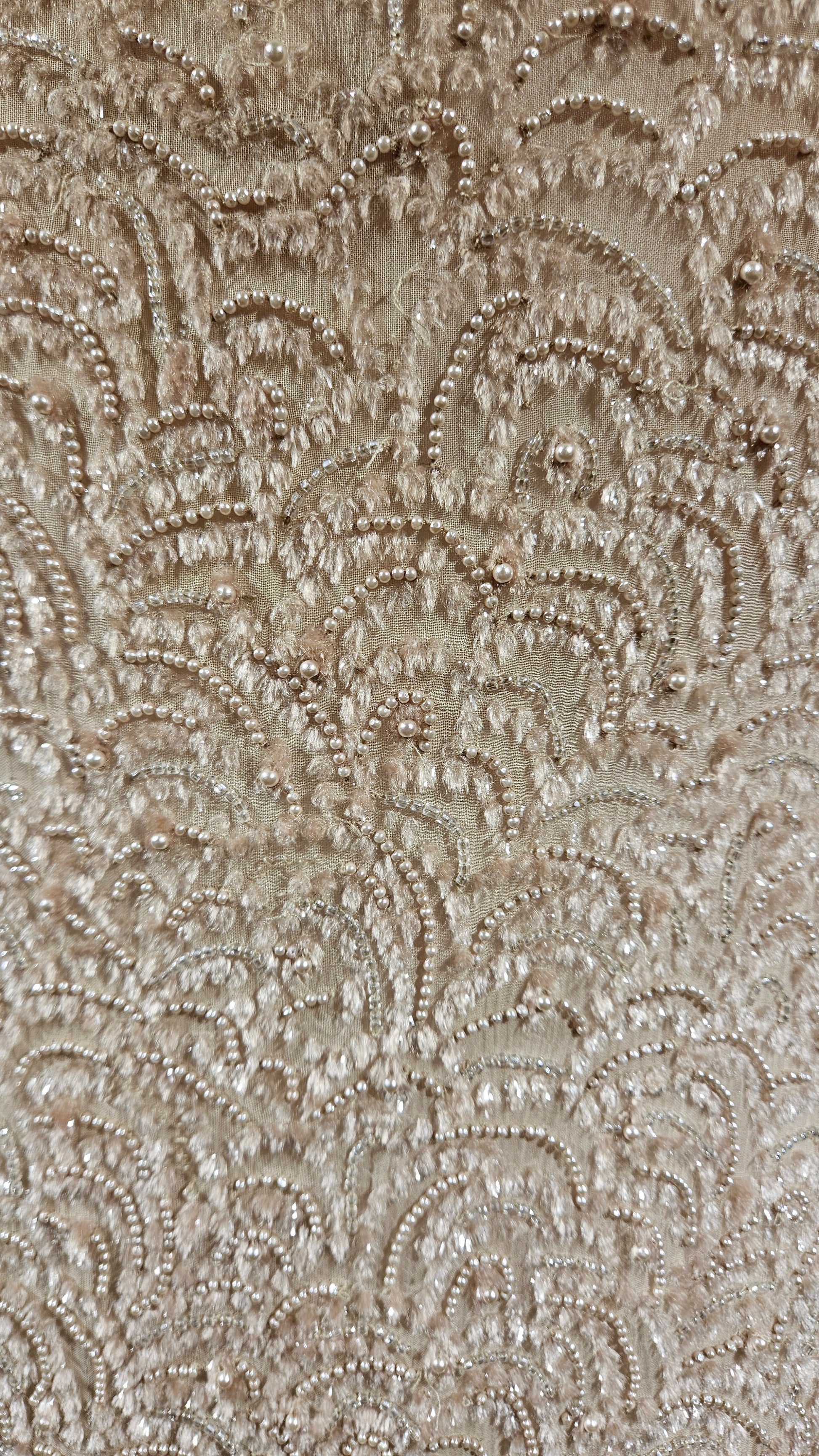 Close-up of a textured beige fabric with intricate patterns