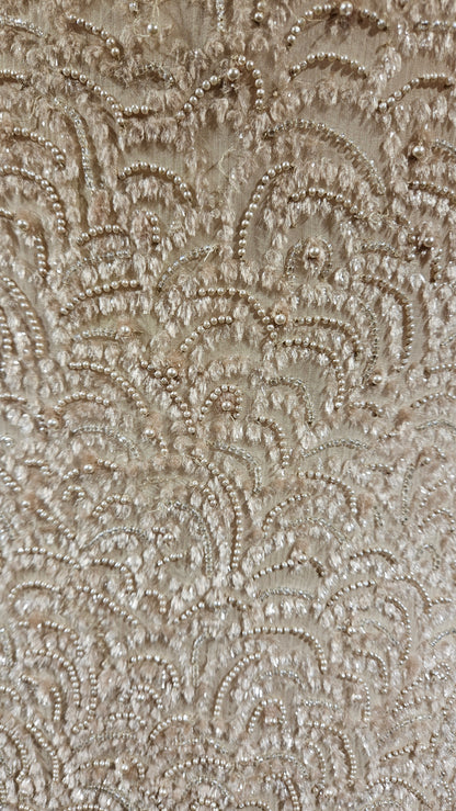 Close-up of a textured beige fabric with intricate patterns
