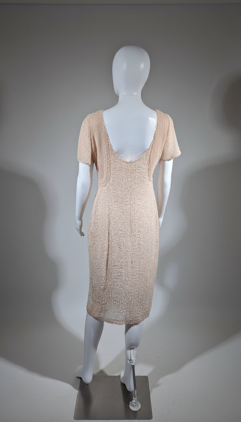 Mannequin wearing a beige dress against a yellow curtain background