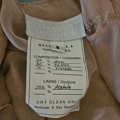 Close-up of a label on a brown fabric item with visible text.