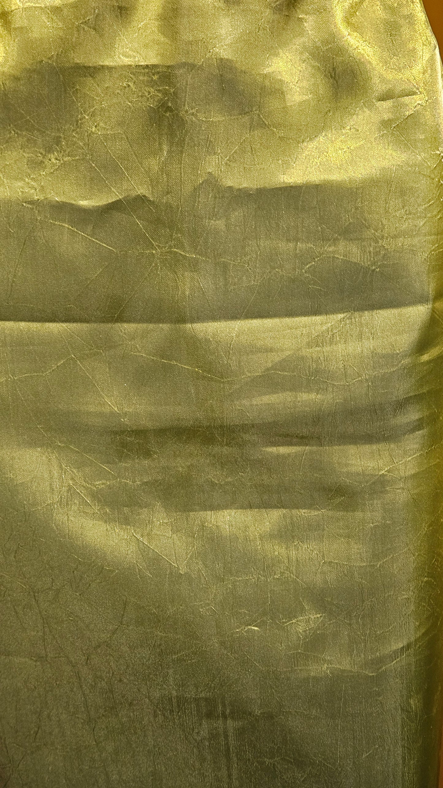 Close-up of textured green fabric with visible folds